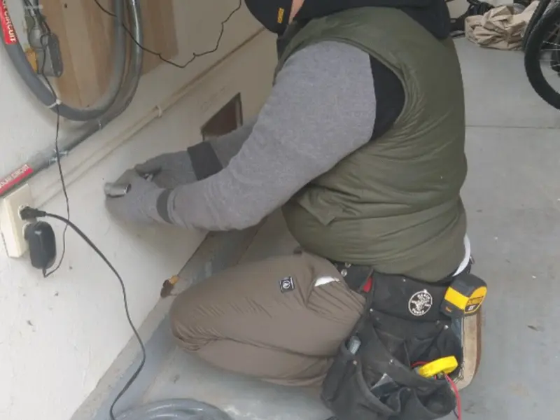 Electrician performing outlet wiring in a Willow Park garage
